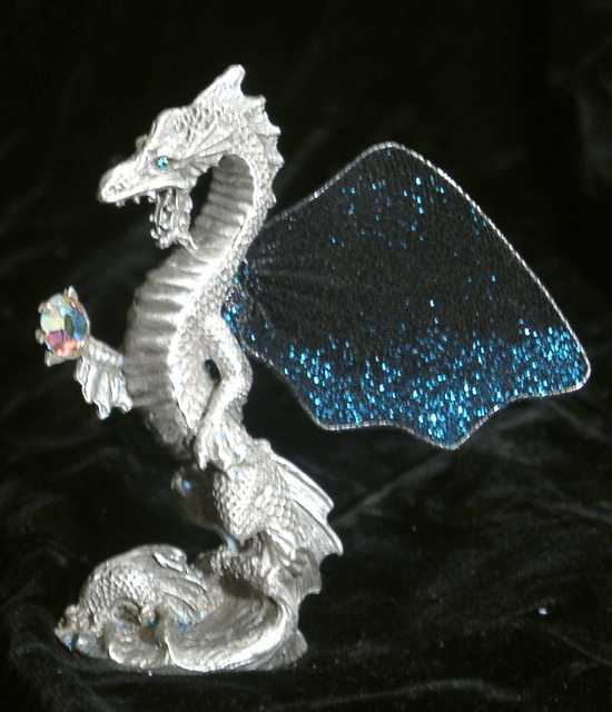 Sea Wyrm - Fairy-winged wyrm rises up from the waves, bearing a jewel.